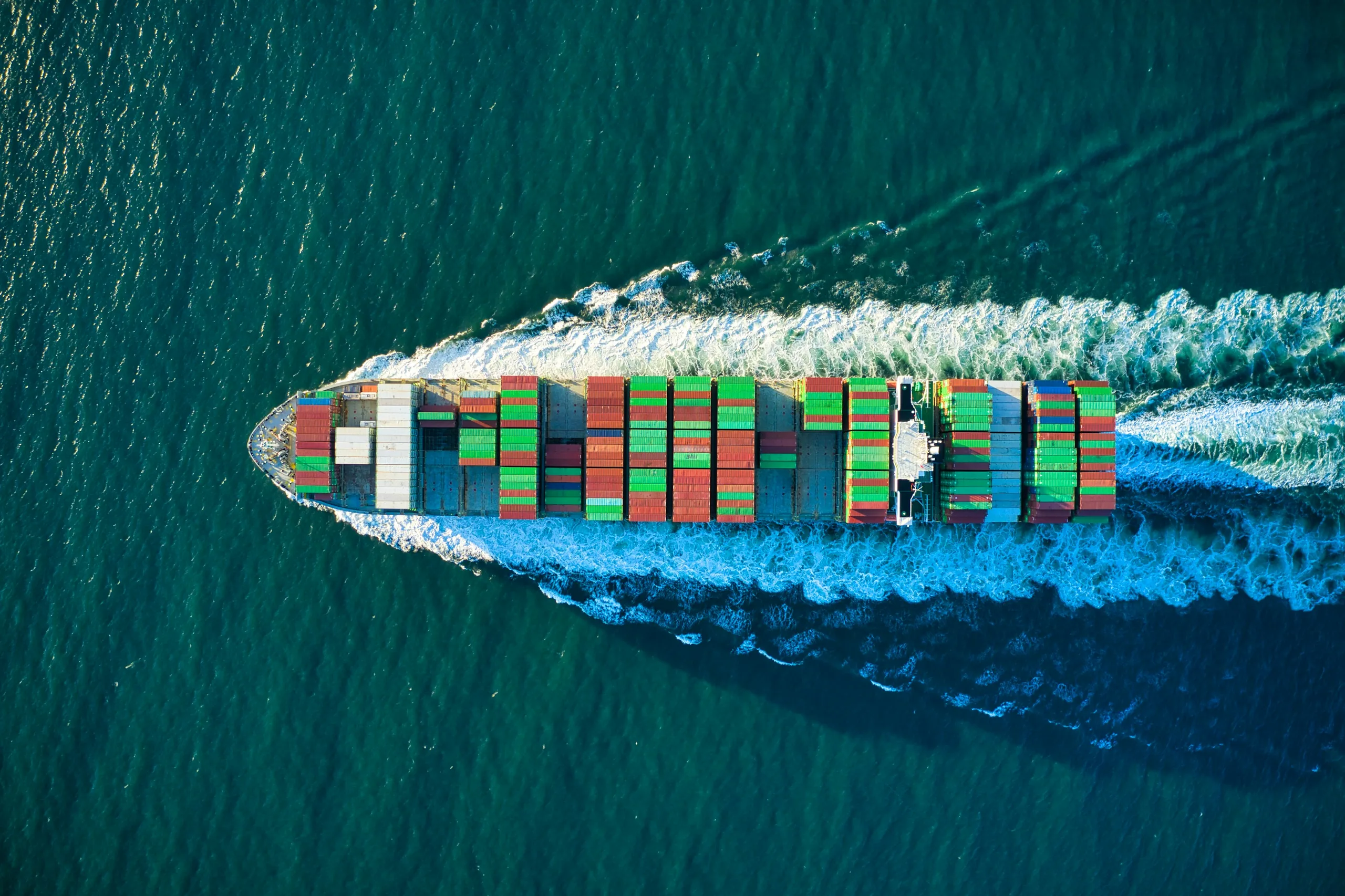 High-resolution aerial view of a container ship crossing open water